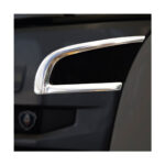 Pega cromada para automóvel em fundo escuro.